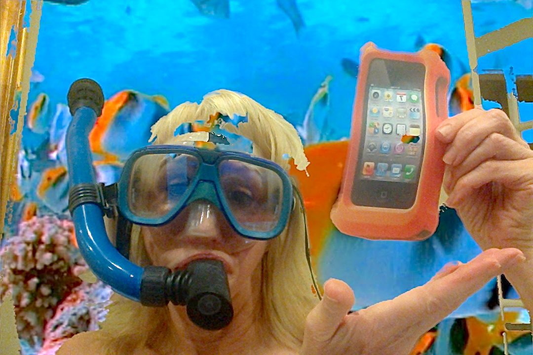 Woman in fake aquarium holding iPhone in LifeProof case